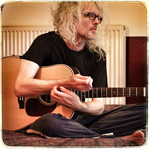 Anton Barbeau with guitar